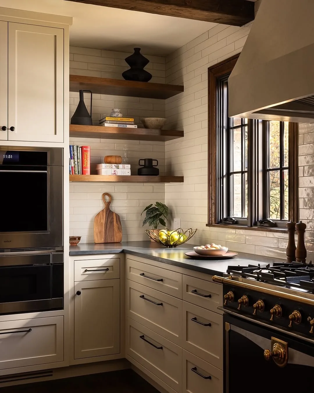 Cream kitchen with a black range and floating shelves
