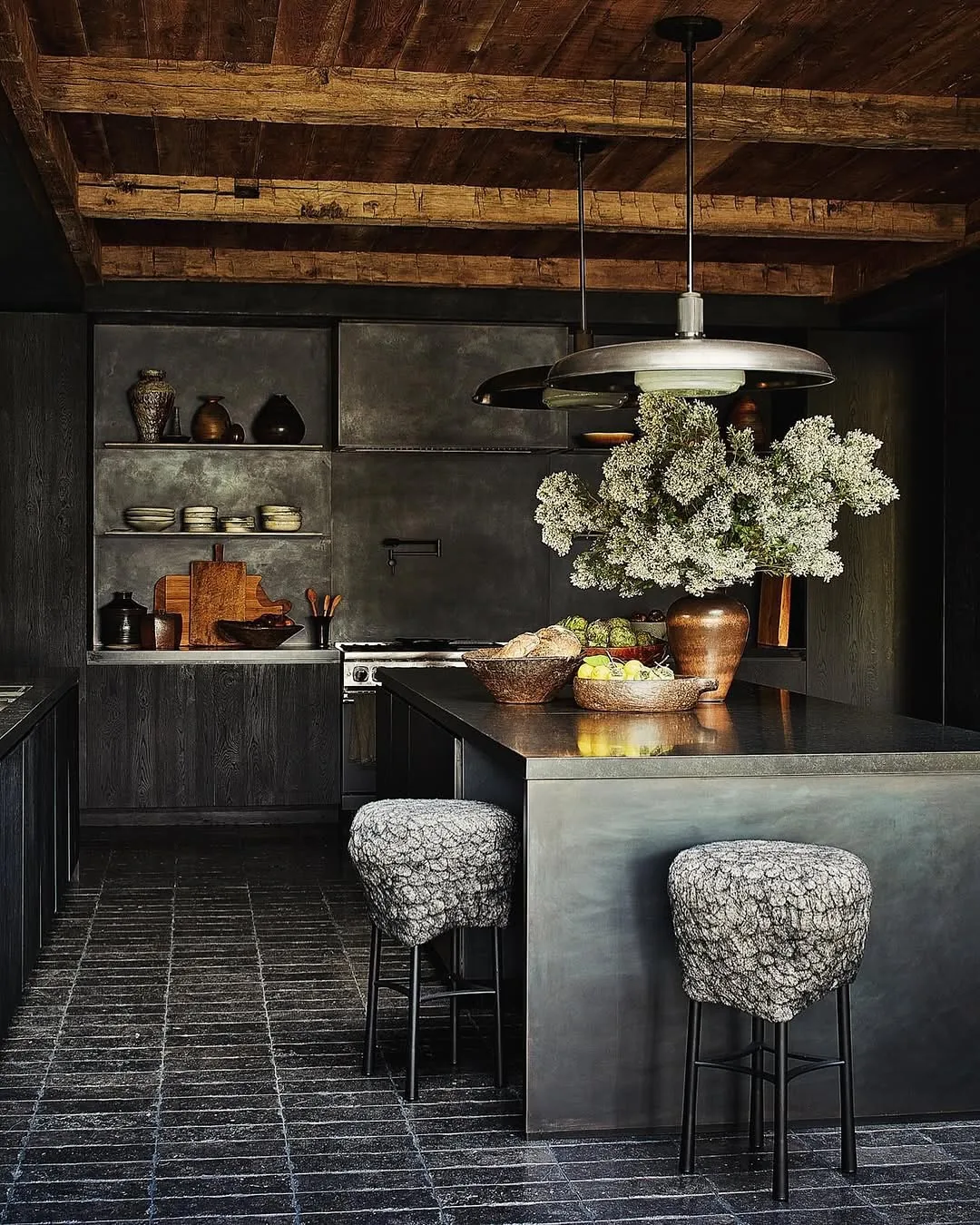 Dark moody kitchen interior with layered warm light