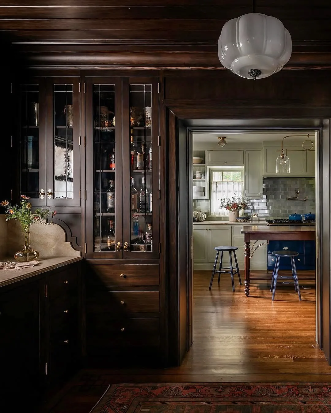 Dark wood butler's pantry with glass cabinets