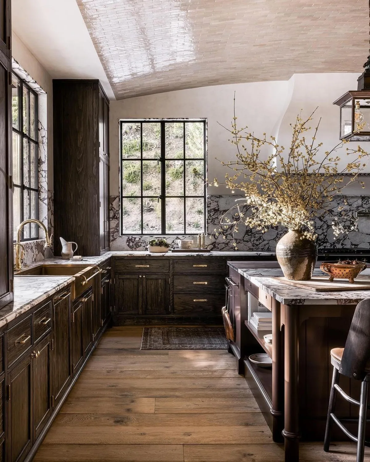 Dark wood kitchen with marble countertops