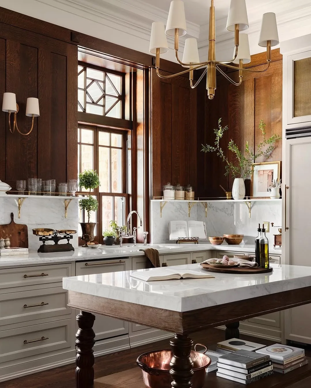 Dark wood paneled kitchen with a marble island