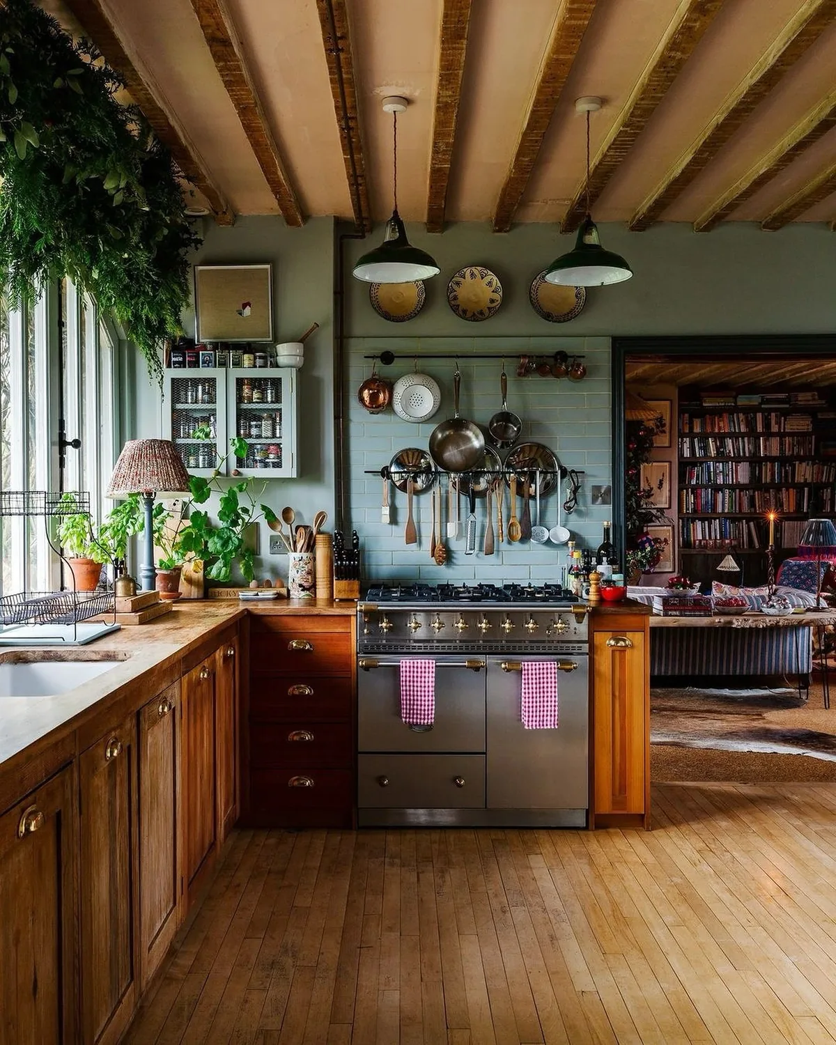 Rustic farmhouse kitchen with copper pots and a range