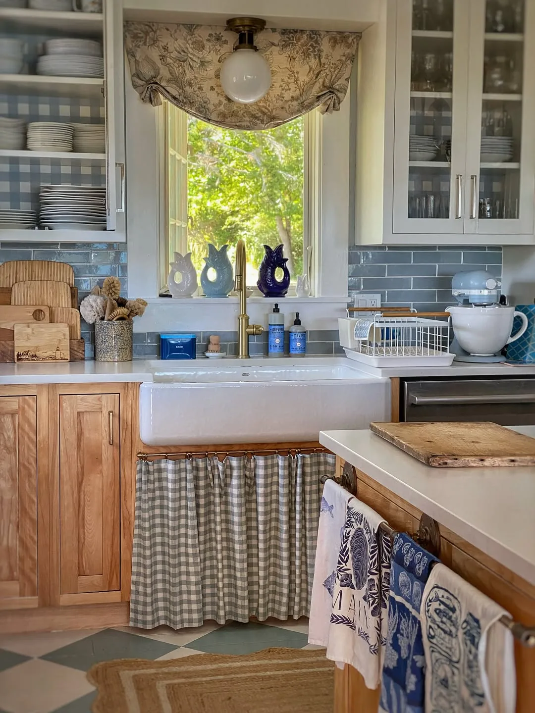 Cottage kitchen with a farmhouse sink and gingham curtain