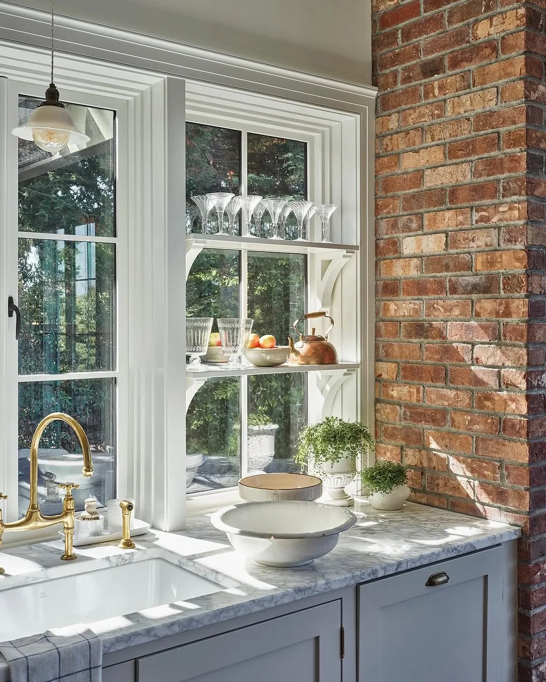 Farmhouse kitchen sink under a sunny window