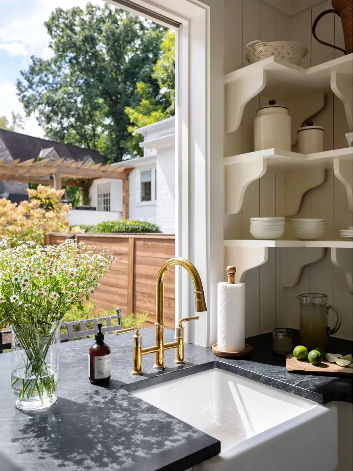 Gold faucet kitchen sink with open shelving