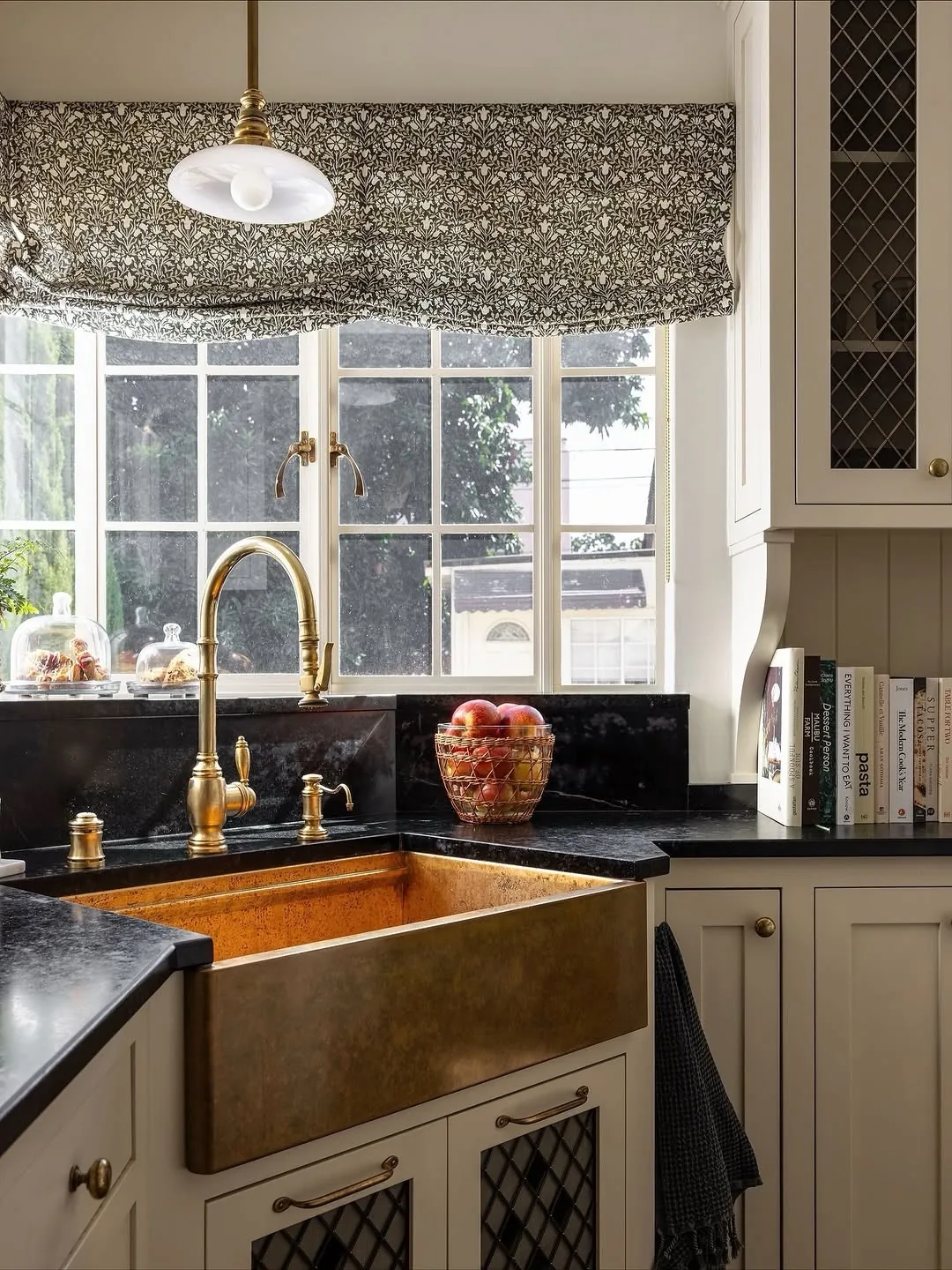 Vintage brass farmhouse sink in a styled kitchen