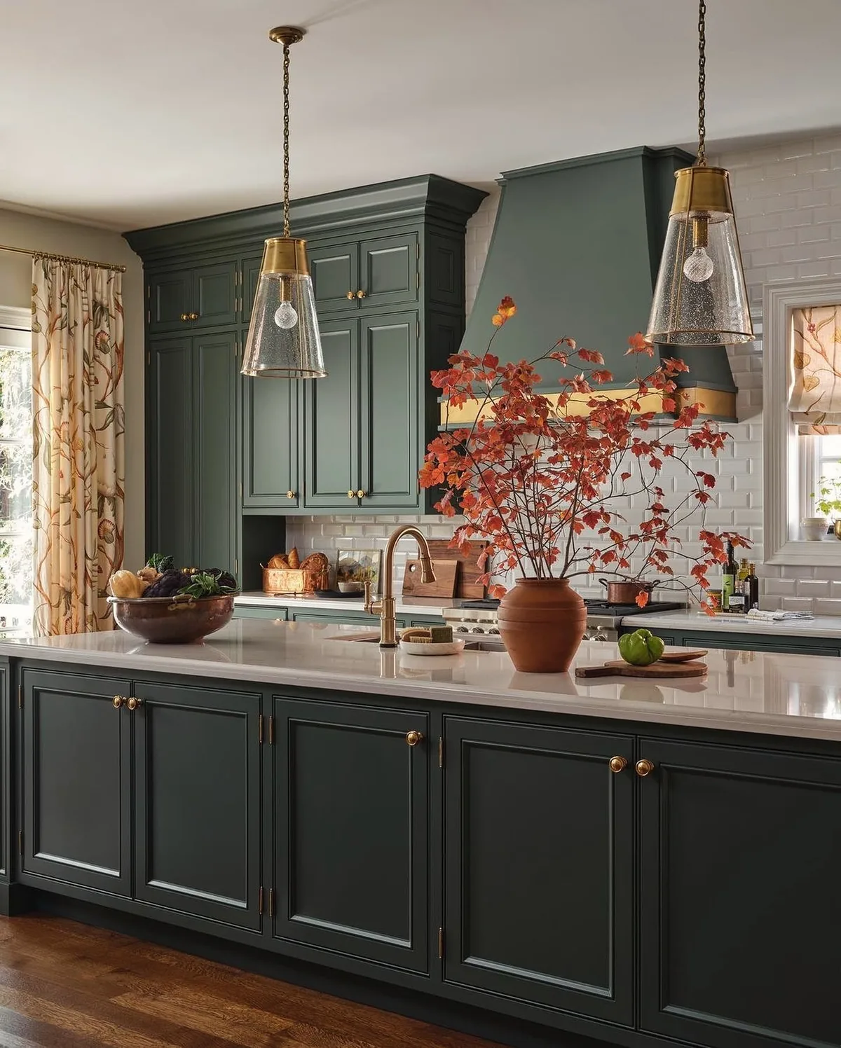 Dark green kitchen cabinets with brass hardware