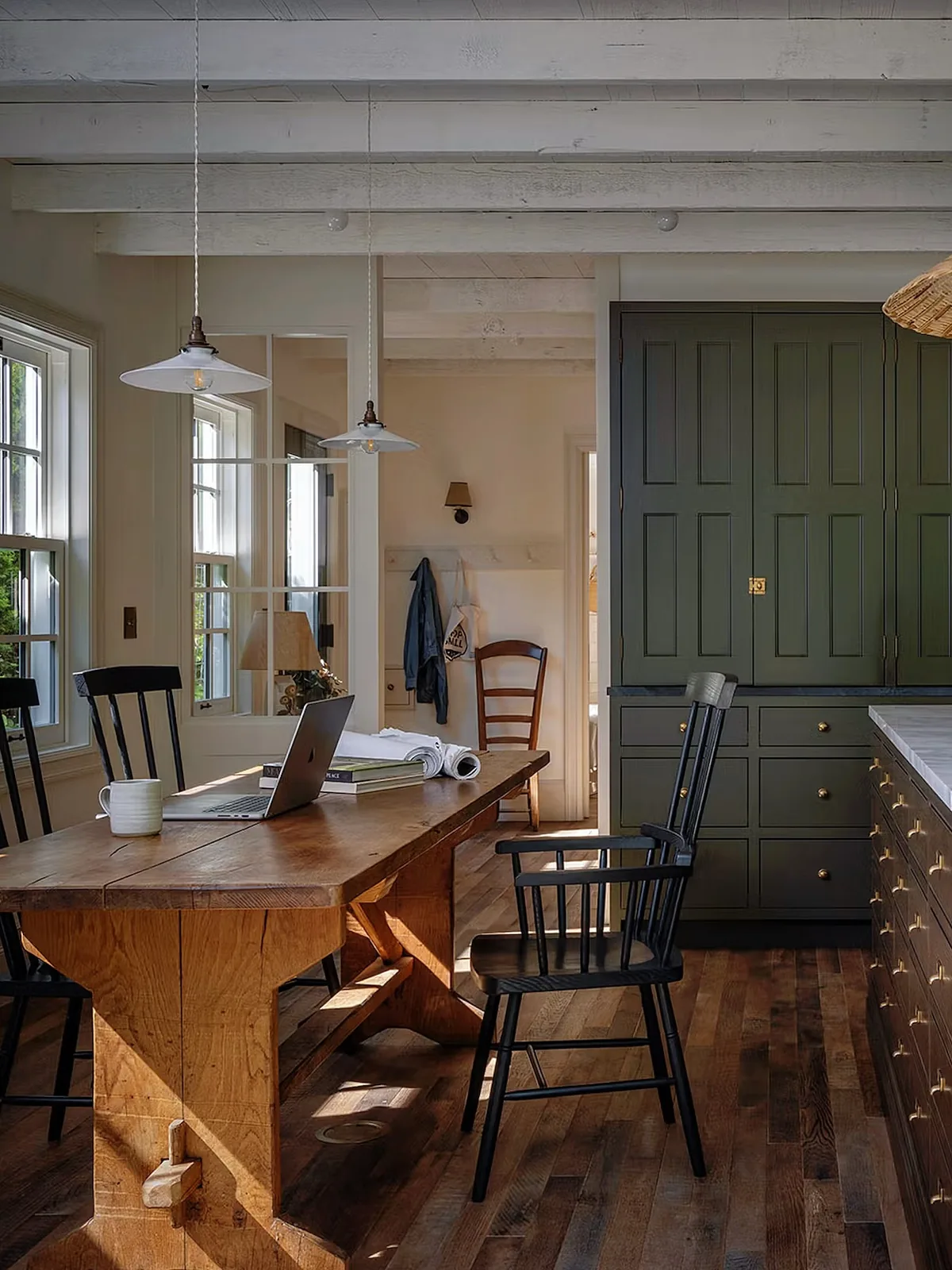 Dark green kitchen cabinets in a rustic farmhouse
