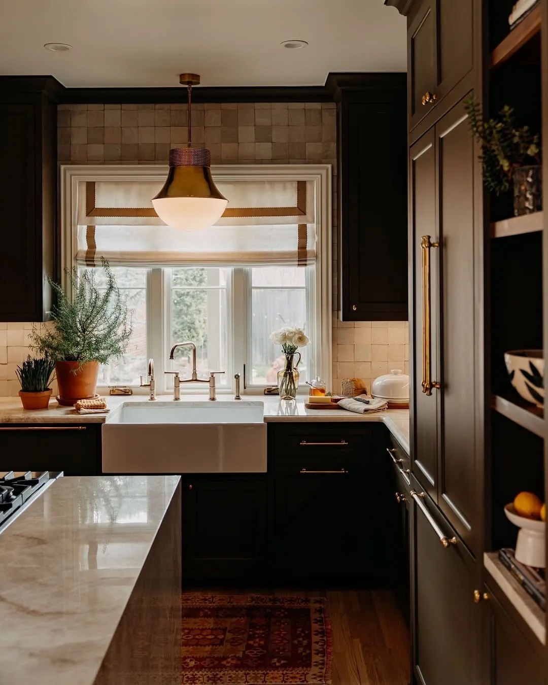 Dark green kitchen with a farmhouse sink and Roman shade
