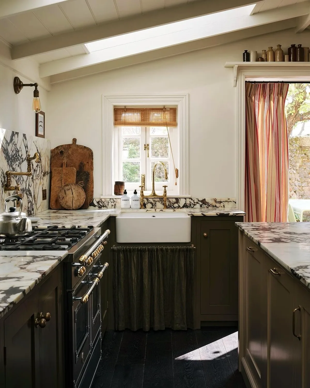Dark green kitchen with a marble skirted sink