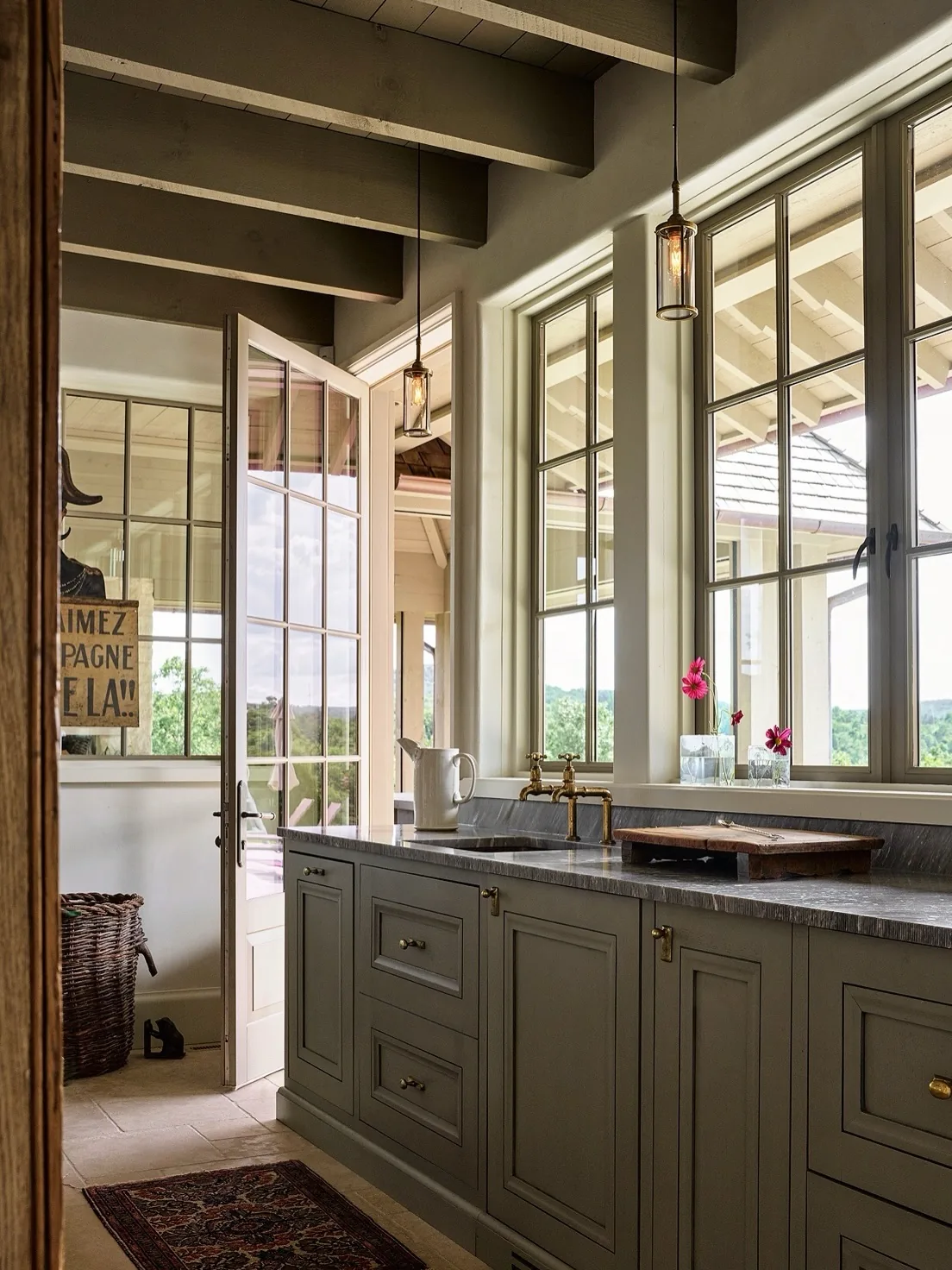 Green cabinet kitchen with a wall of windows