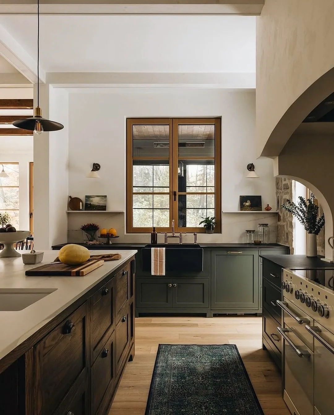Green kitchen with arched plaster and wood windows