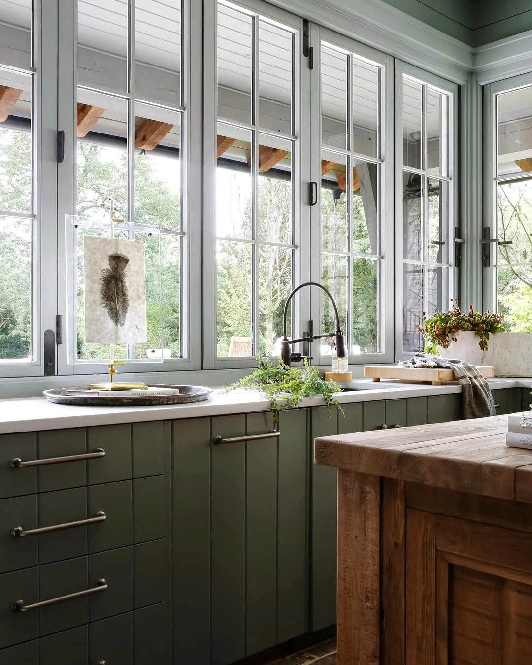 Green kitchen cabinets design with brass accents