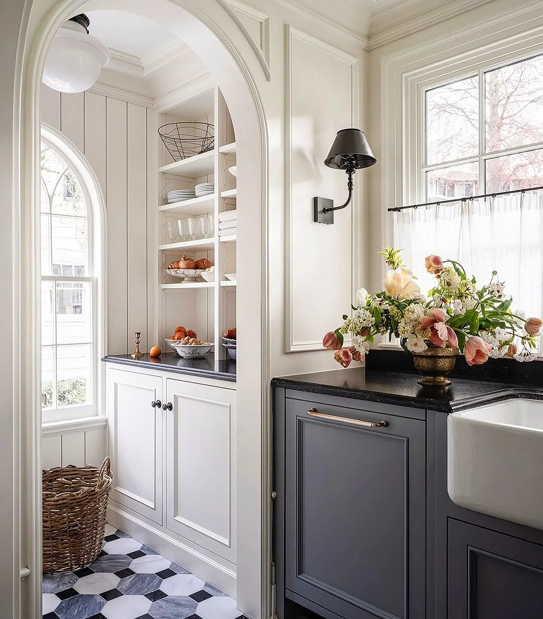 White kitchen with an arched nook and checkered floor