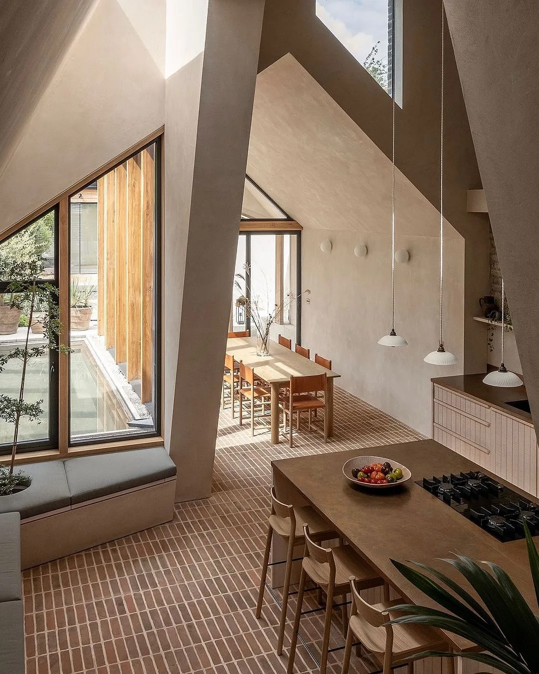 Modern plaster kitchen with a brick floor and window seat