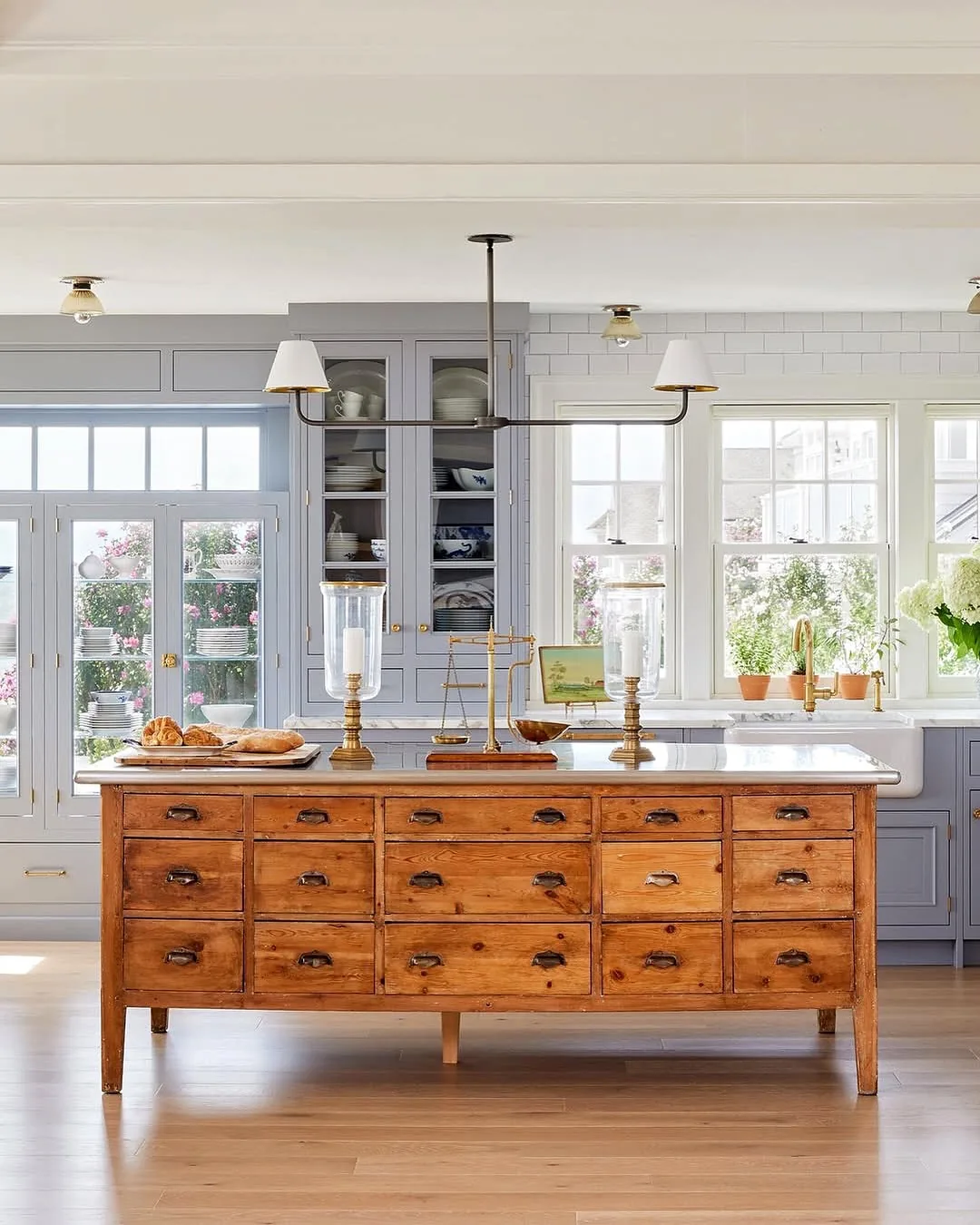 White kitchen with an antique apothecary island