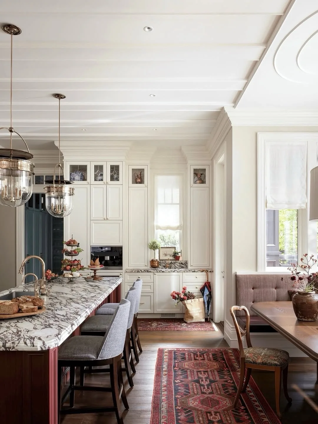 Granite island with white cabinets and a Persian rug