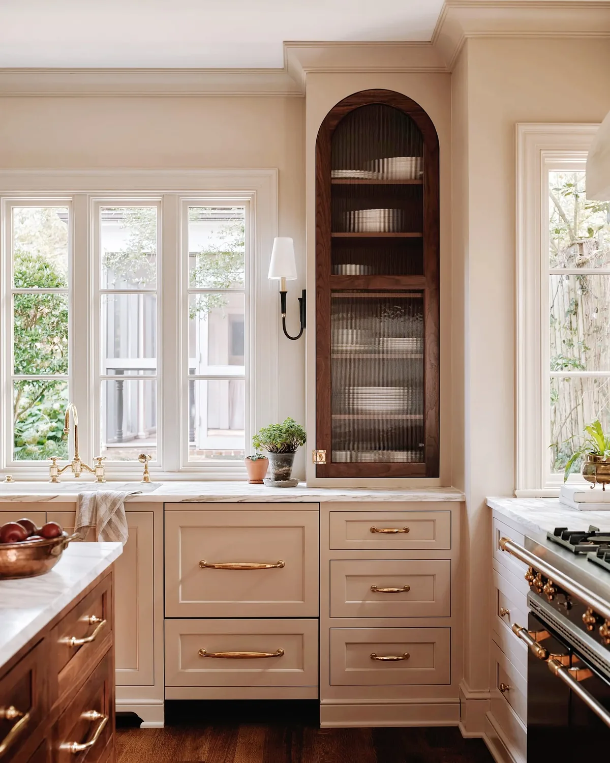 Beige kitchen cabinets with marble countertops