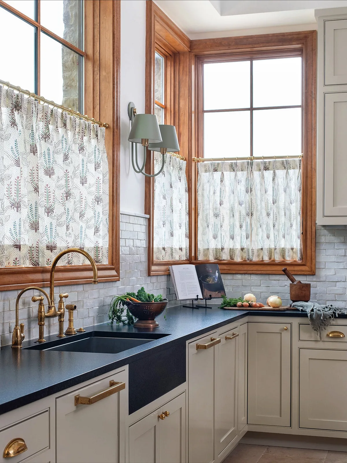Soapstone counter kitchen with cafe curtains and wood windows