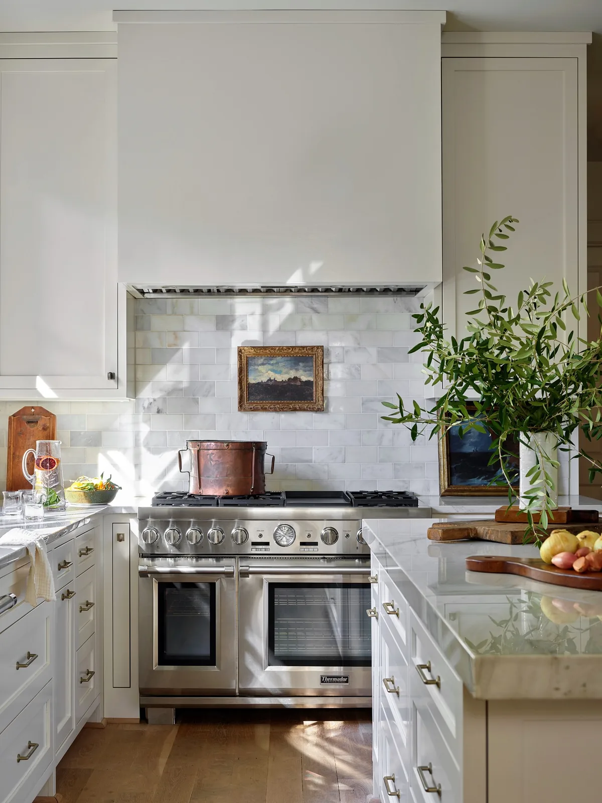 White marble kitchen with a copper pot