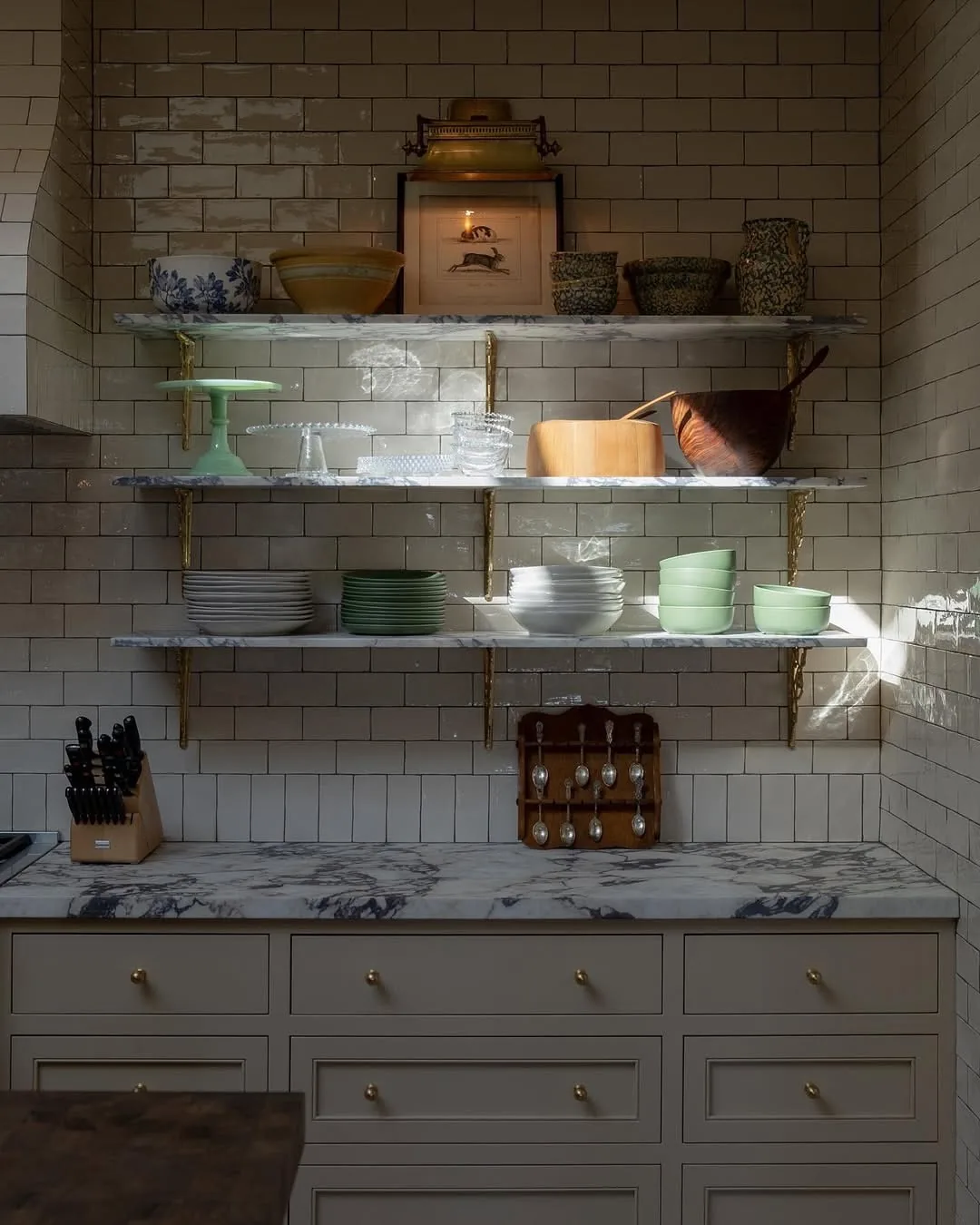 Marble open shelving with subway tile kitchen