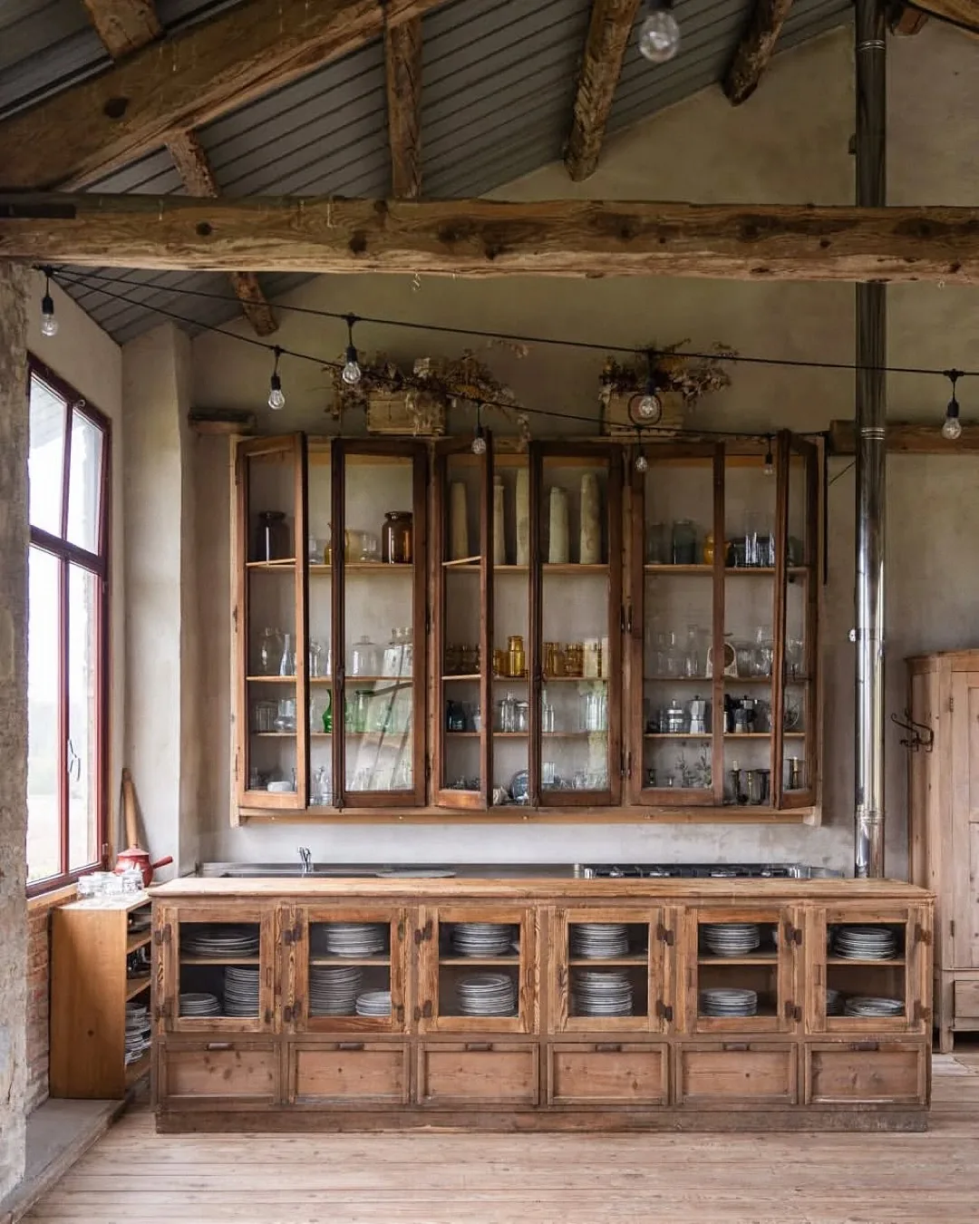 Rustic barn kitchen with antique glass cabinets