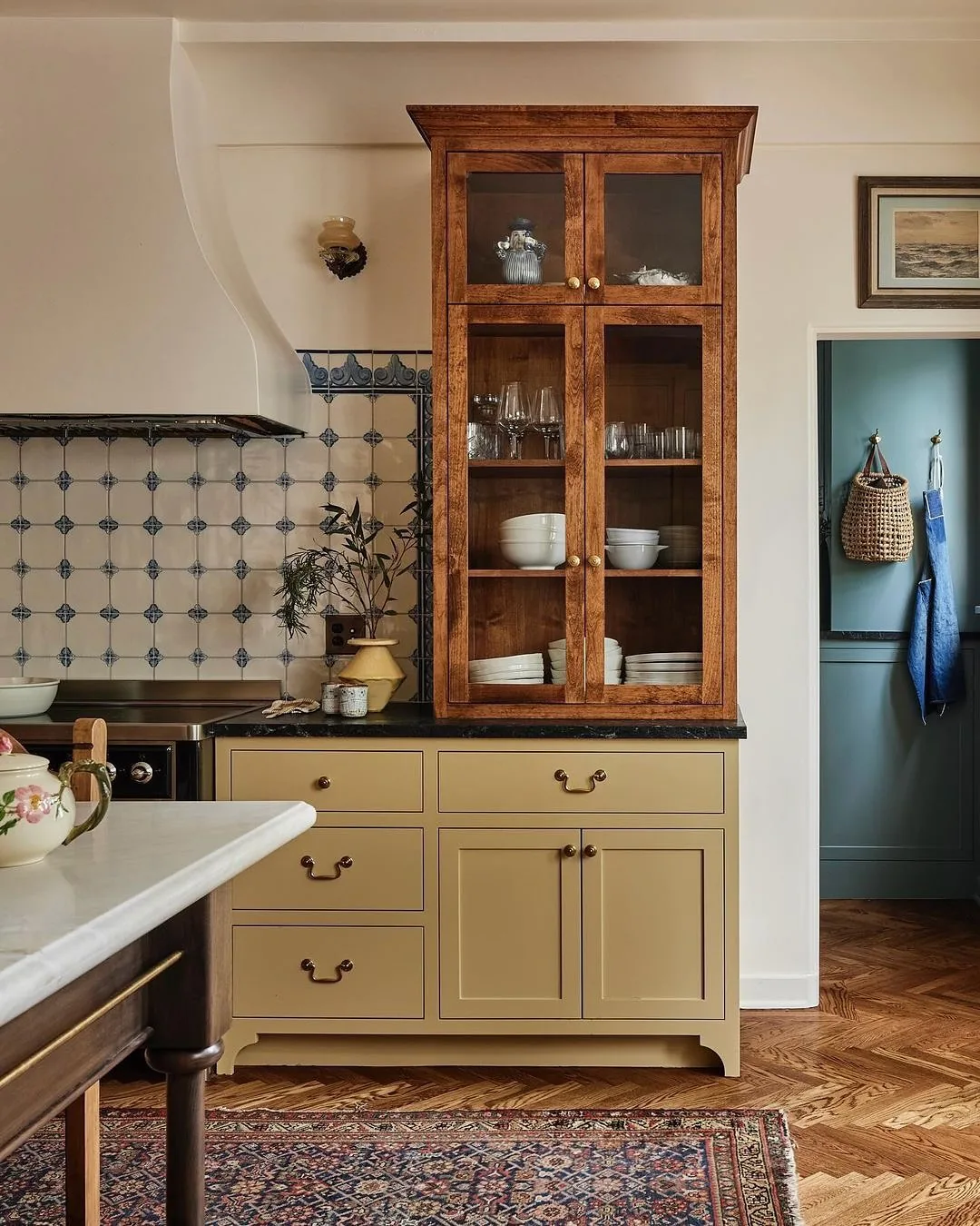 Yellow cabinet kitchen with an antique hutch