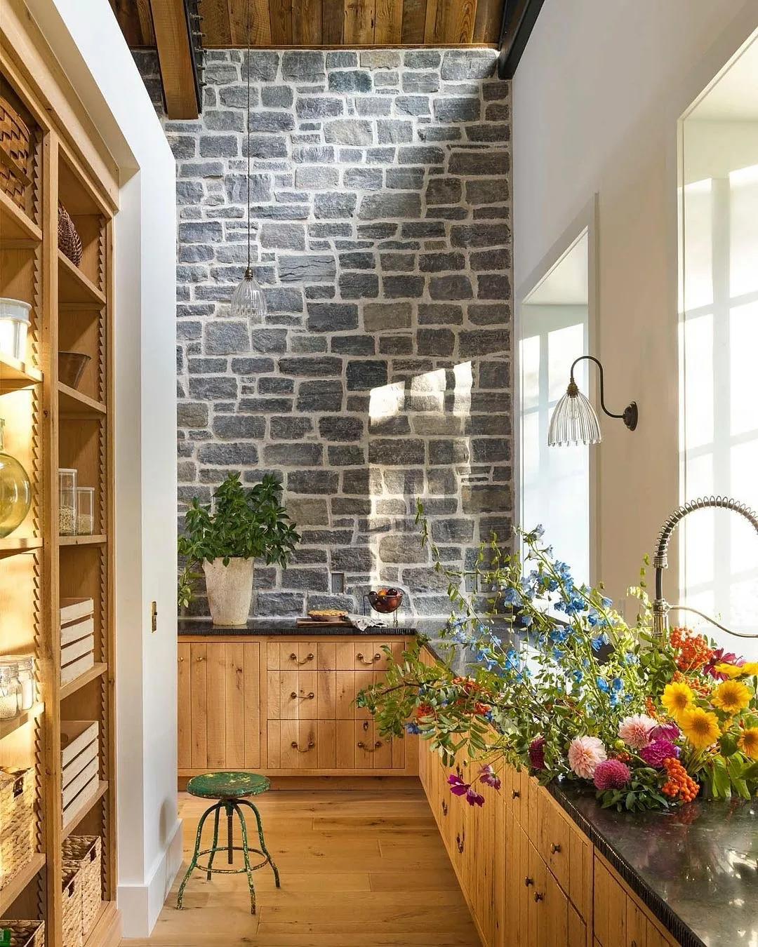 Stone chimney pine kitchen with a flower arrangement