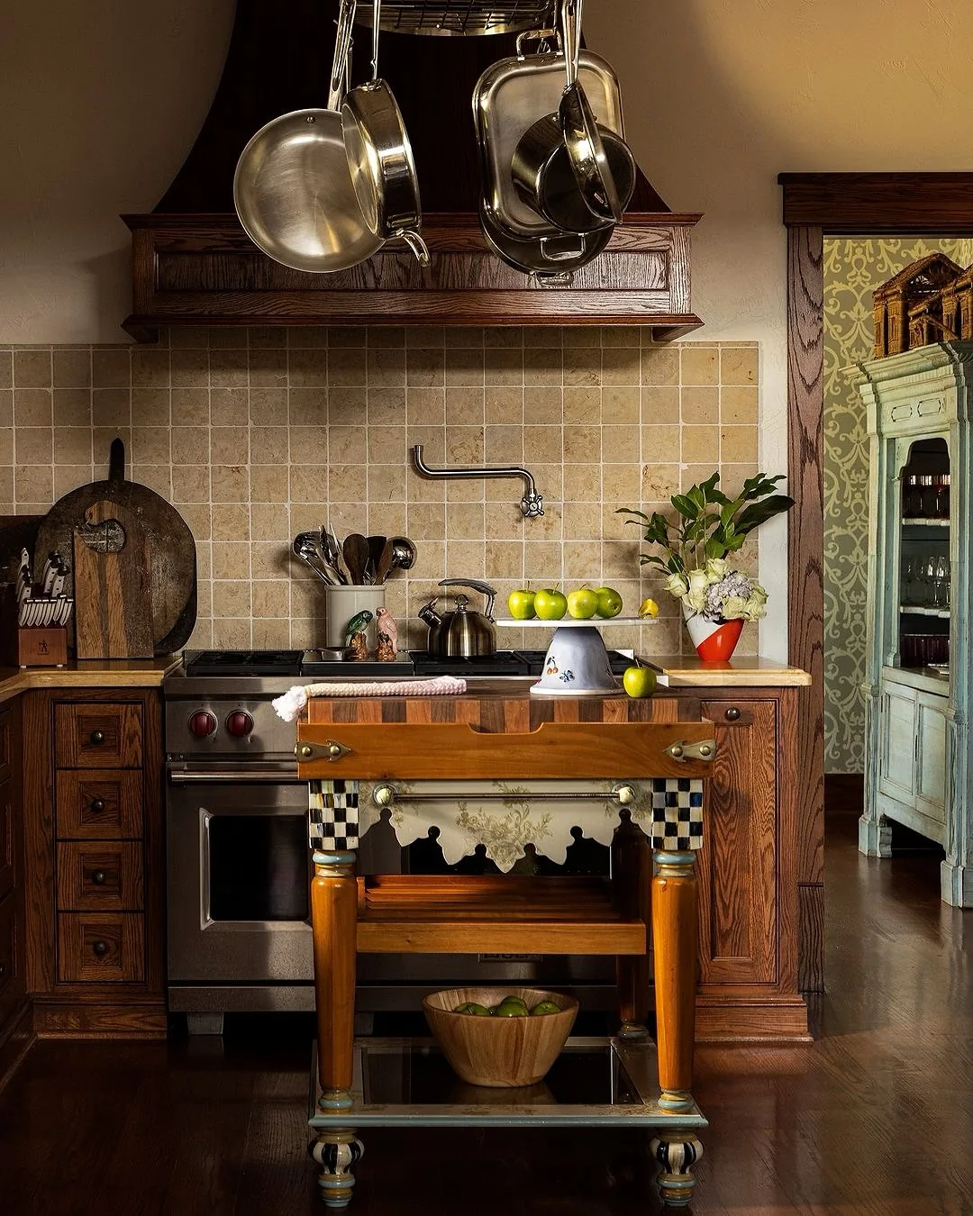 Vintage oak kitchen with a copper hood and butcher block