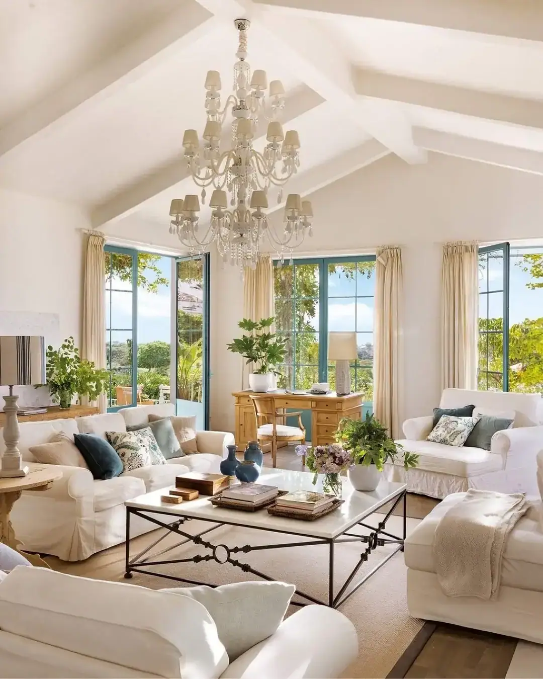 Bright white vaulted ceiling living room with tall windows and soft furnishings