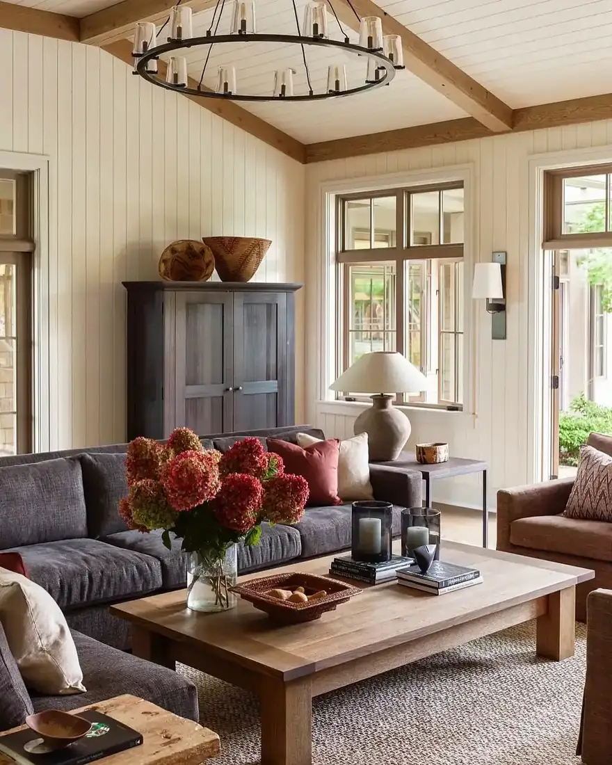 Farmhouse living room with wood beams, vaulted ceiling and soft textiles