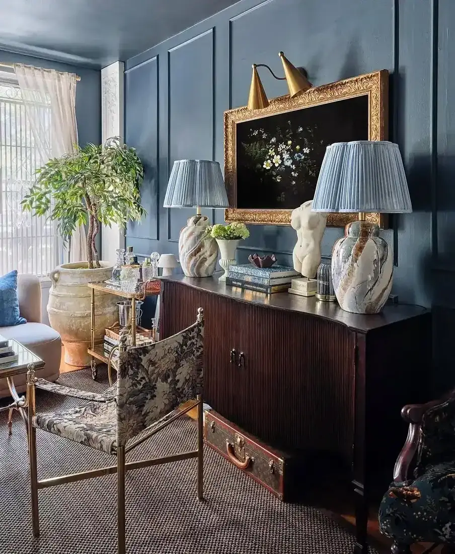 Moody blue wall panelling in a living room with vaulted ceiling and warm light