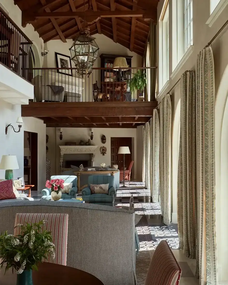 Spanish colonial living room with beamed ceiling, fireplace and layered textiles