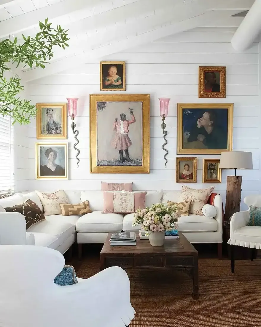 White living room with portrait gallery wall, vaulted ceiling and soft furnishings