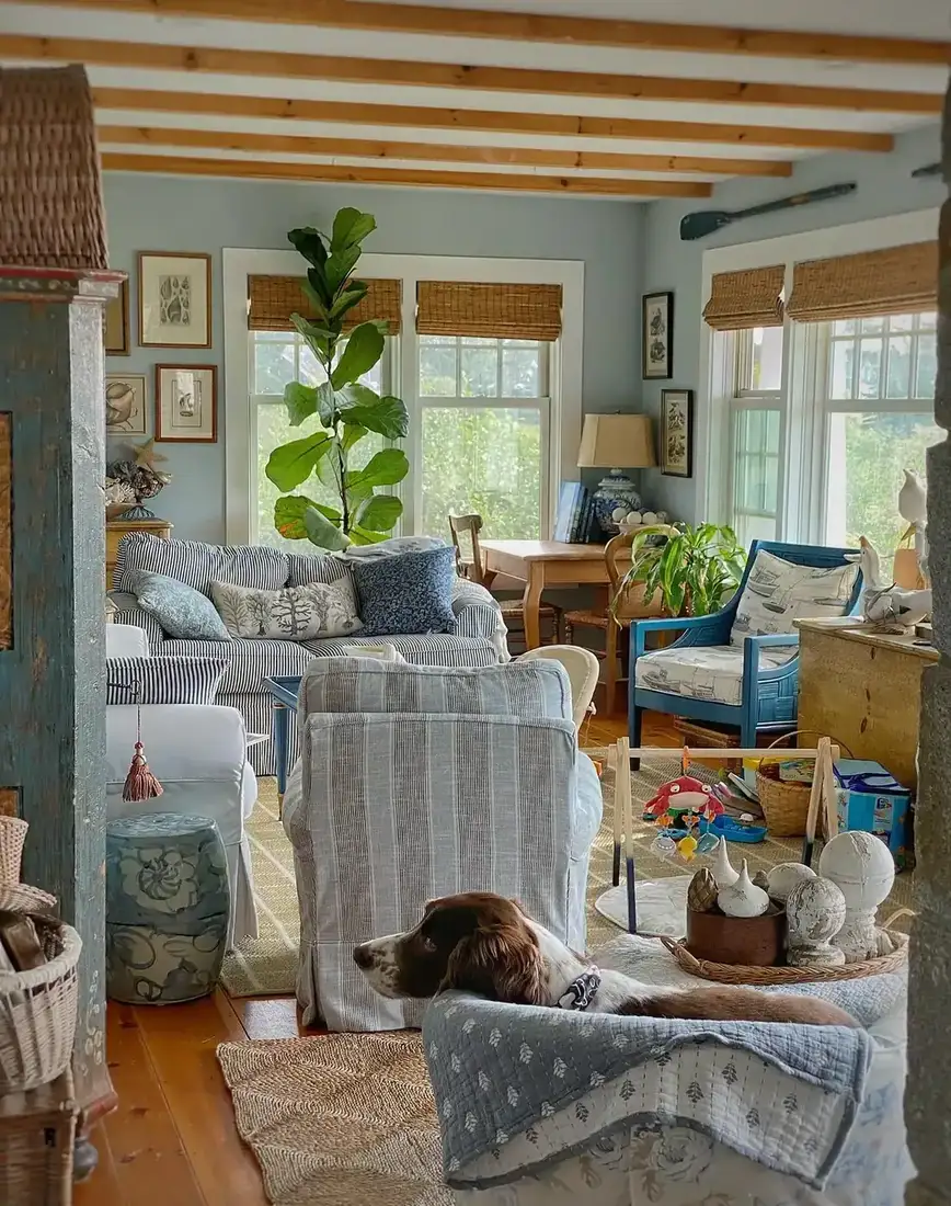 Blue and white coastal cottage living room with striped textiles and natural light