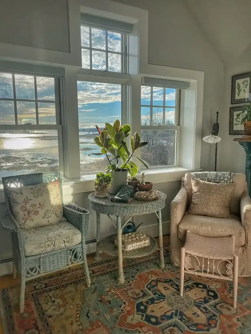 Coastal sunroom with wicker chairs, blue and white textiles and natural light