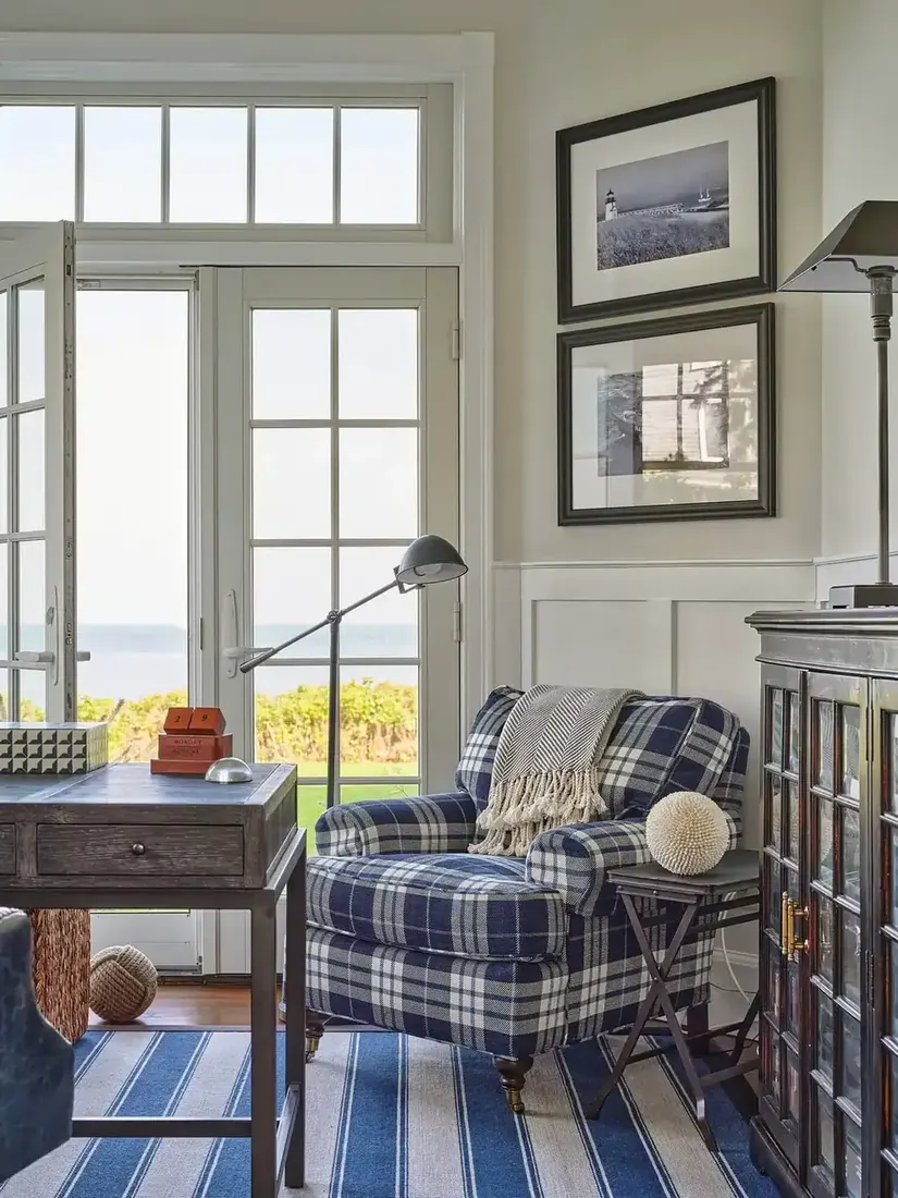 Nautical plaid armchair in a blue and white living room with coastal textiles