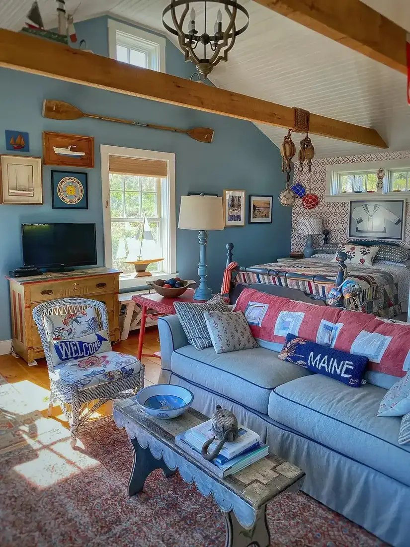 Coastal living room with blue and white decor, striped textiles and timber table
