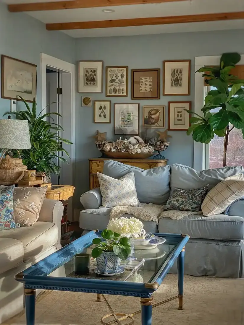 Traditional coastal living room with gallery wall, blue and white textiles and warm lighting