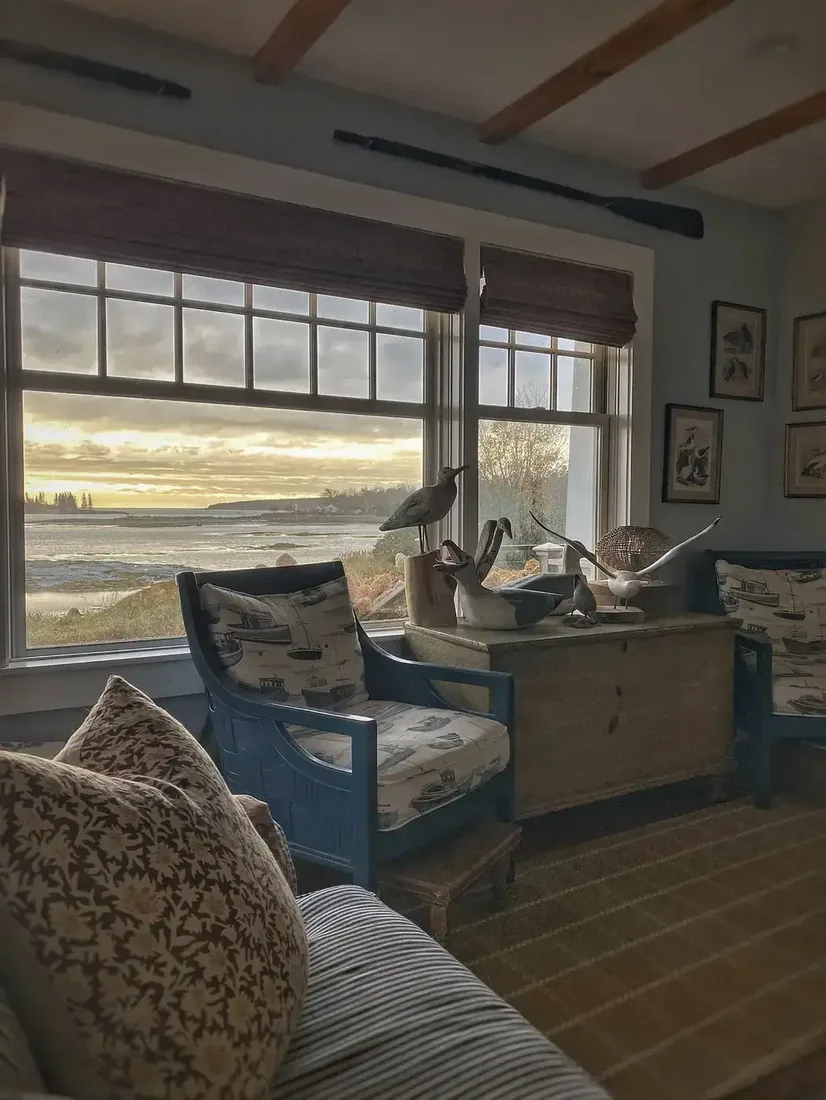 Vintage coastal living room with blue and white decor, timber accents and soft light