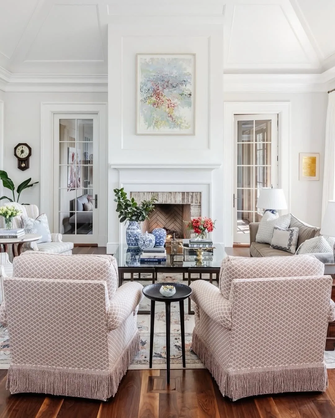 White living room with fringed chairs and blue ginger jars