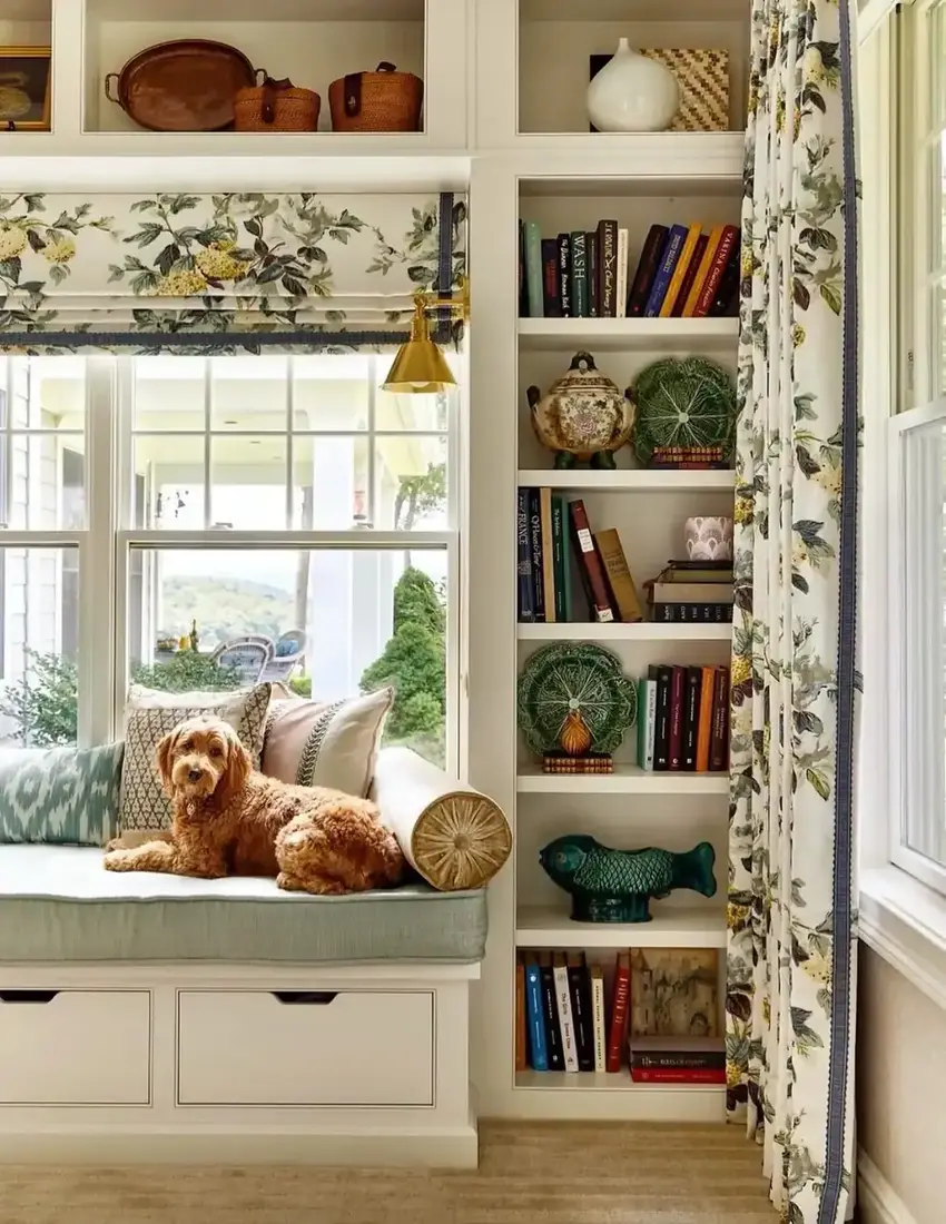 Cozy window seat with built-in bookshelves and dog on cushion