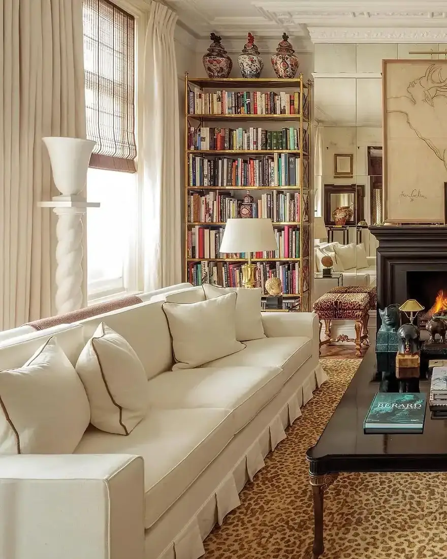 Cream library living room with built-in bookshelves and leopard print rug