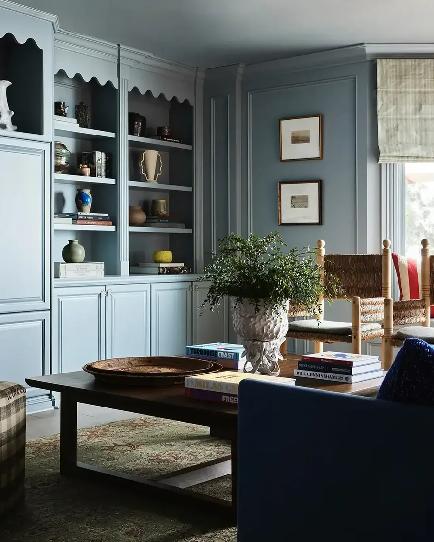 Living room with blue painted built-in bookshelves around a fireplace
