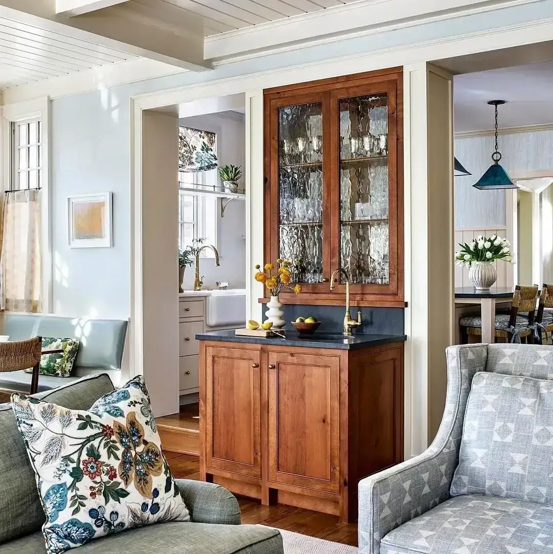 Built-in wood bar cabinet with doors inside living room shelving