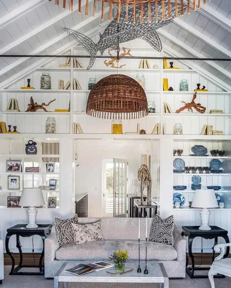 Coastal living room with white built-in shelves and natural woven baskets