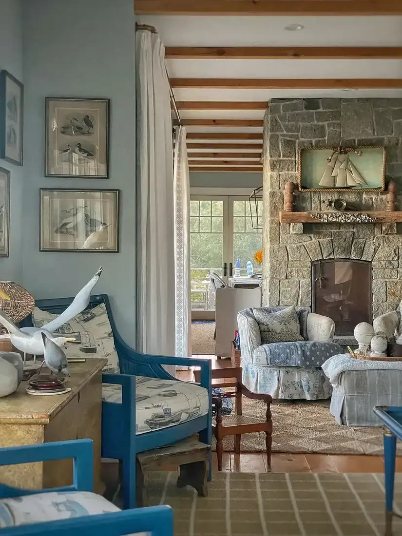 Blue and white coastal living room with striped sofa and harbor light