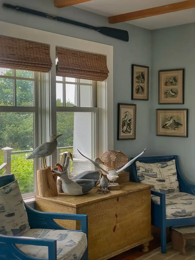 Nautical coastal living room with blue striped sofa and white walls