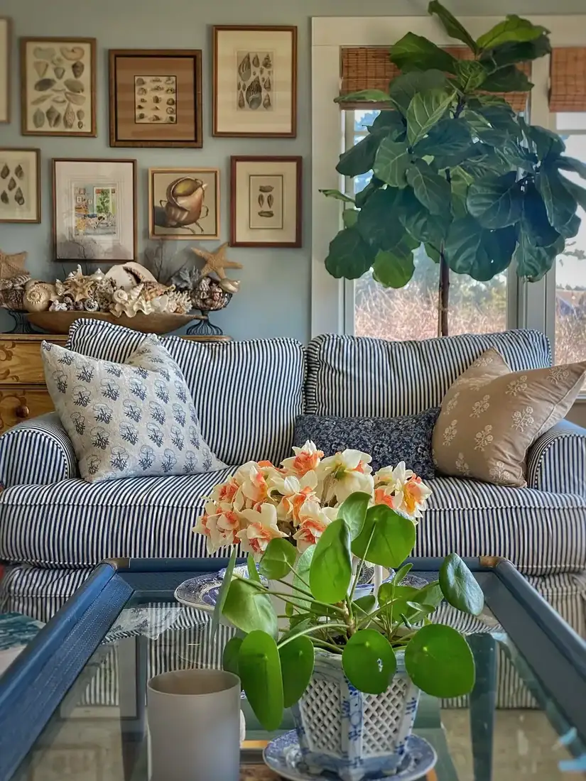 Blue striped sofa in a bright coastal living room with white walls