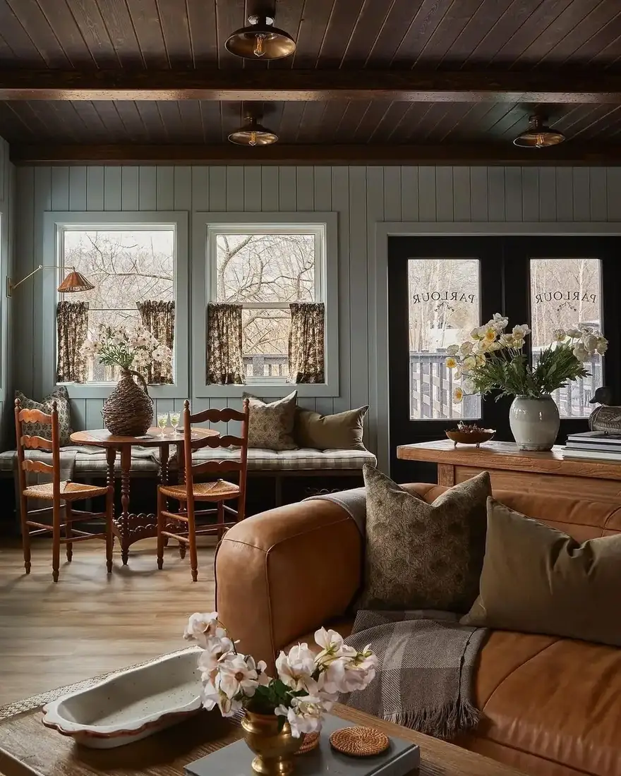 English cottage living room with fireplace, floral textiles and layered patterns